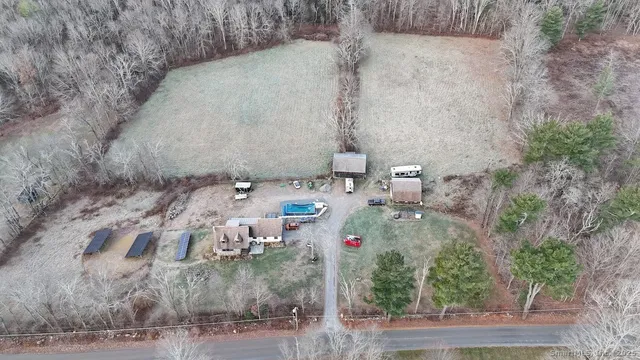 a view of a dry yard with wooden fence