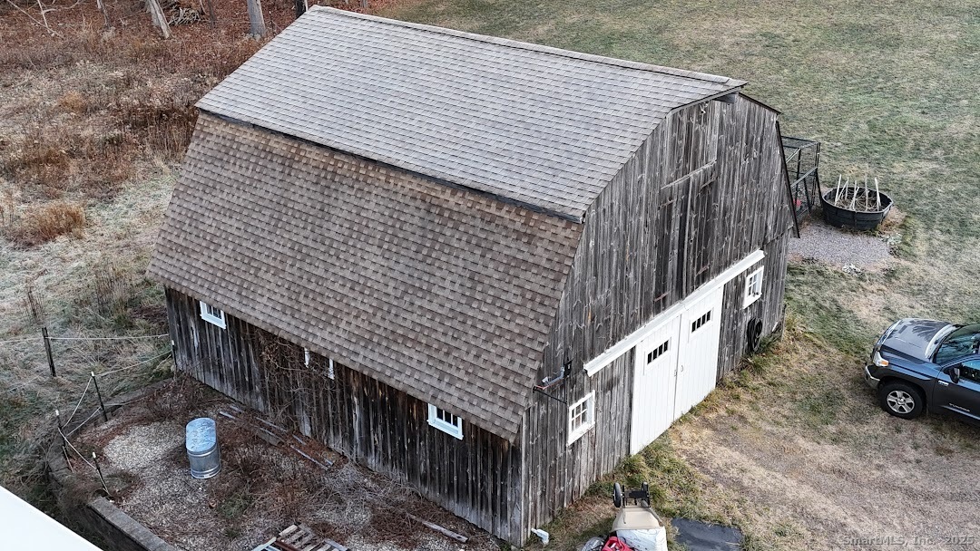 145 Perrin Road Woodstock, CT 06281 - Photo 33 of 38 a view of a wooden house with a deck