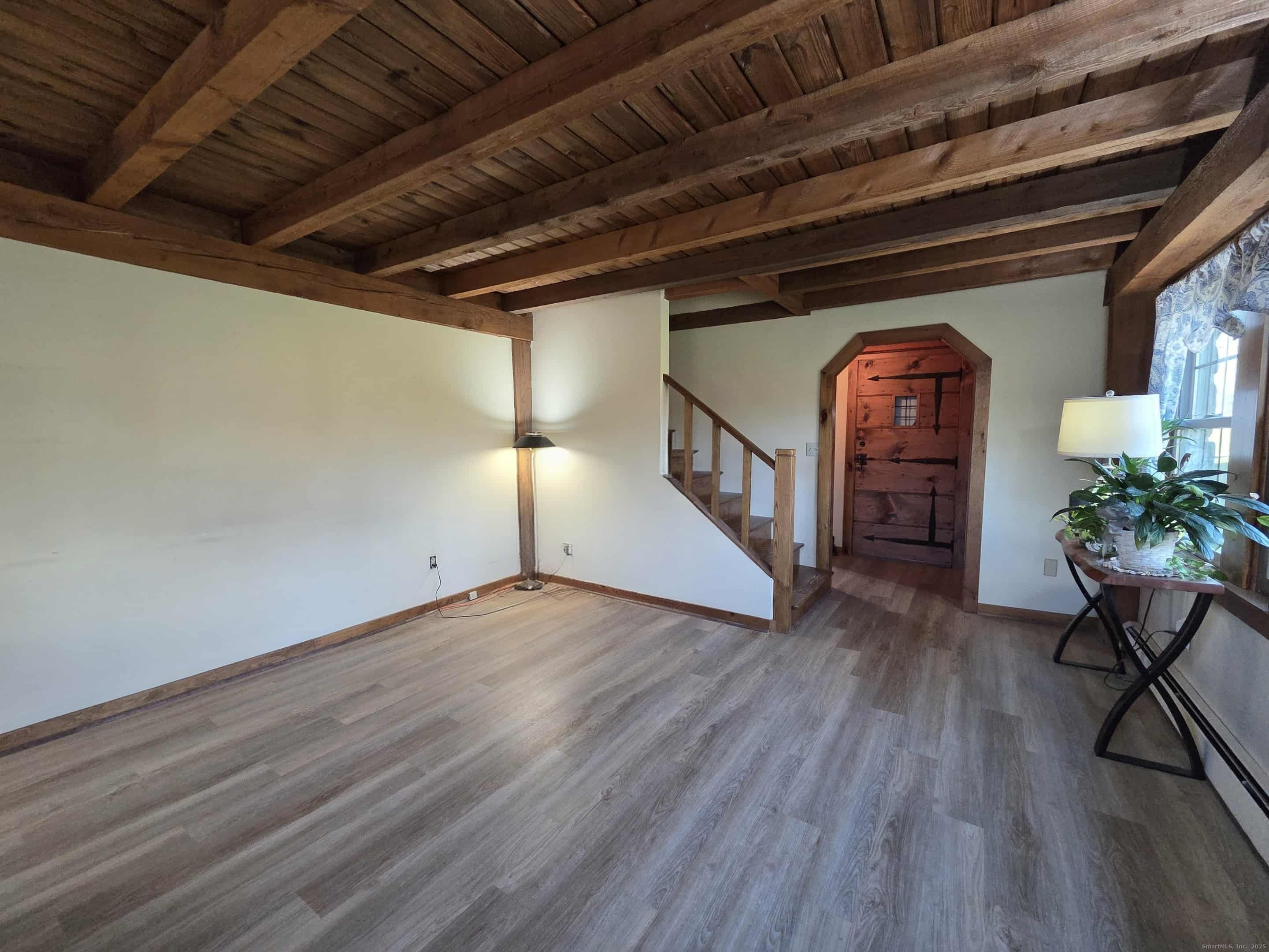 145 Perrin Road Woodstock, CT 06281 - Photo 10 of 38 a view of an empty room with wooden floor and a window
