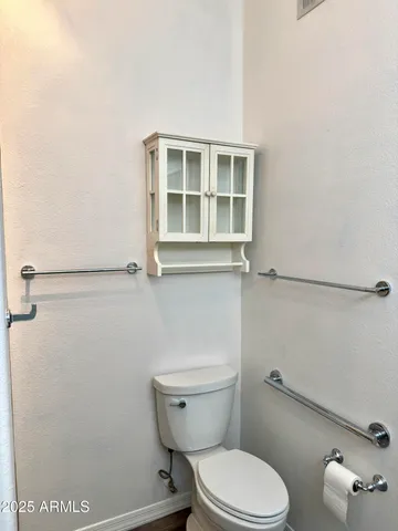 a white toilet sitting next to a bathroom sink