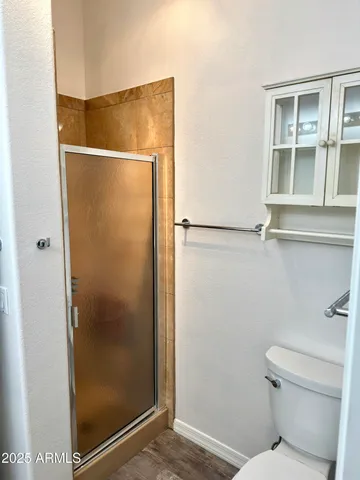 a bathroom with a glass shower door