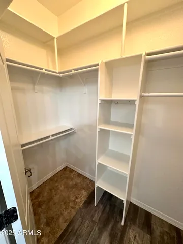 a view of walk in closet with empty racks