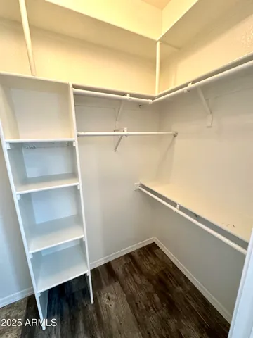 a view of walk in closet with empty racks