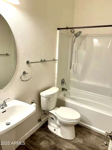 a bathroom with a toilet sink and shower