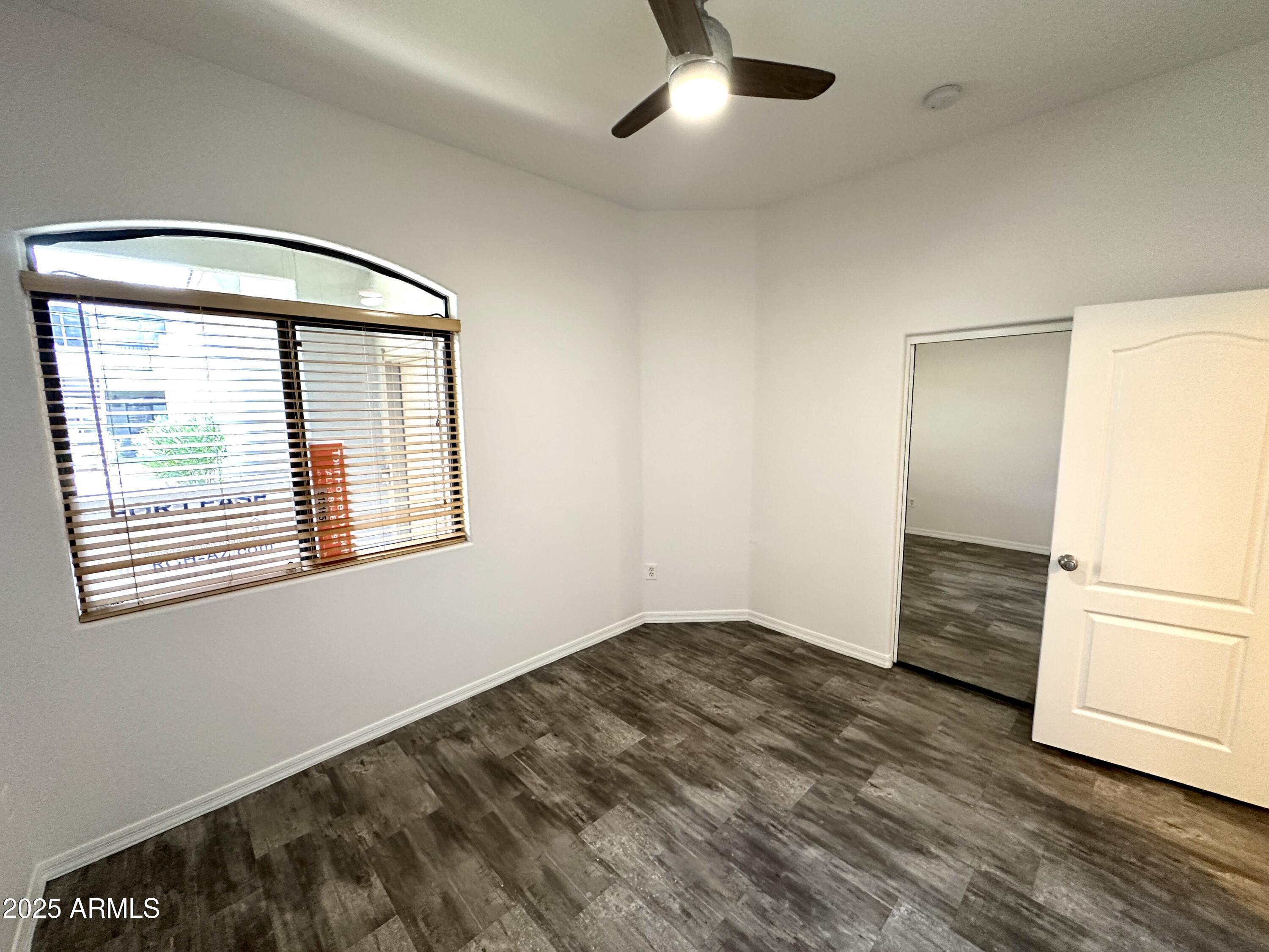 4533 North 22nd Street, Unit 127 Phoenix, AZ 85016 - Photo 23 of 30 a view of an empty room with wooden floor and a window