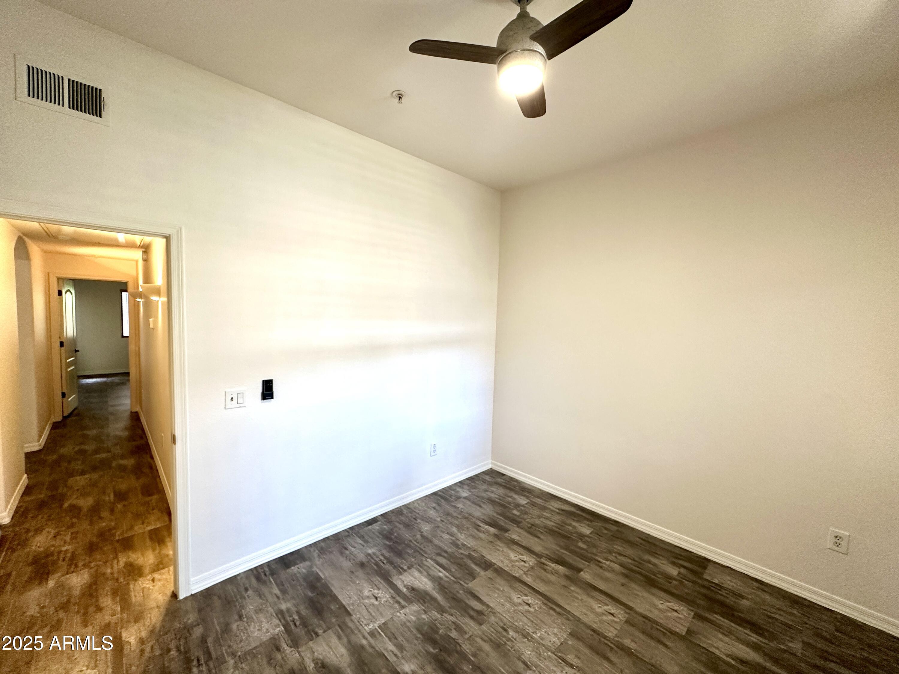 4533 North 22nd Street, Unit 127 Phoenix, AZ 85016 - Photo 30 of 30 an empty room with wooden floor and windows