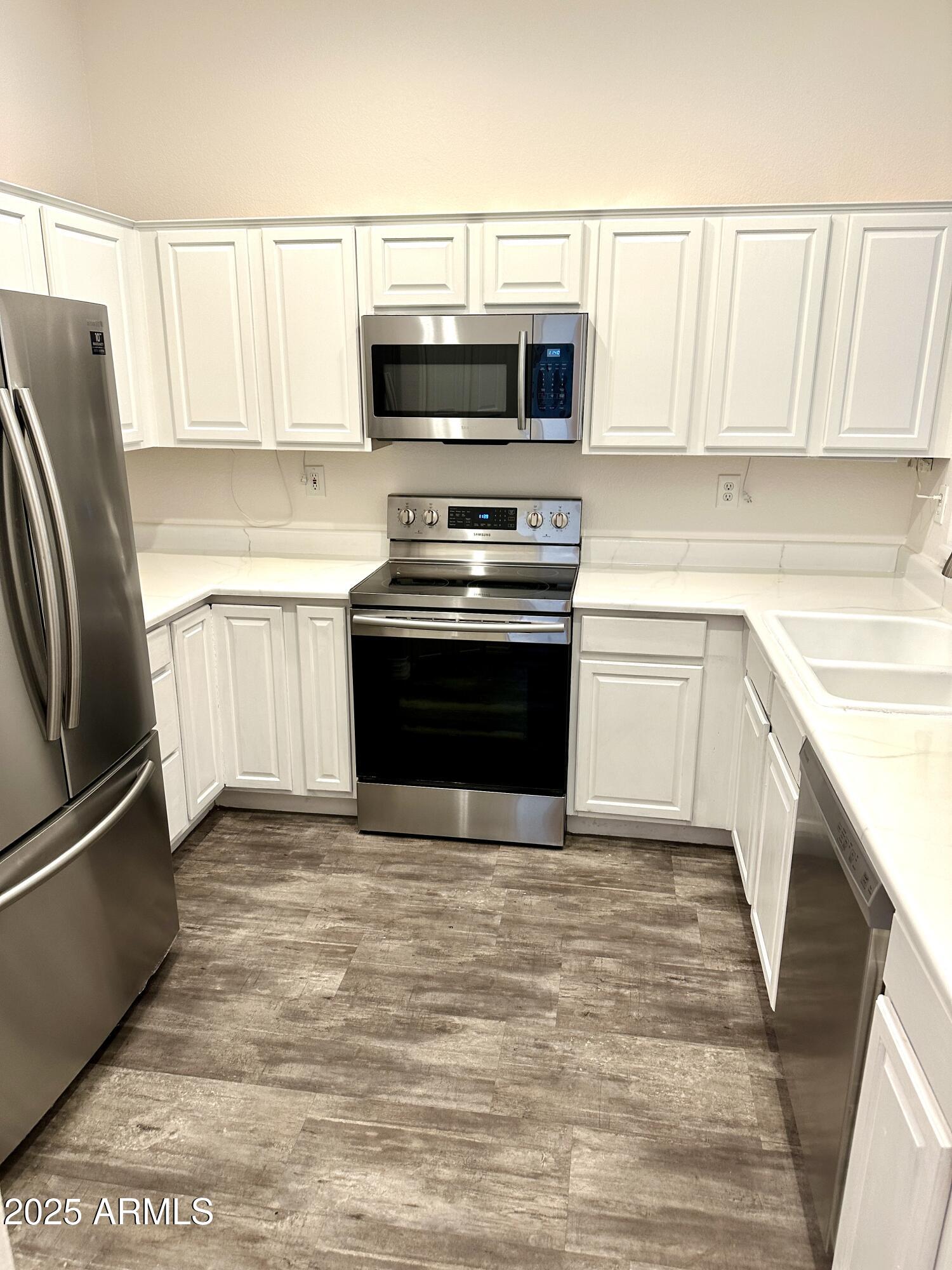 4533 North 22nd Street, Unit 127 Phoenix, AZ 85016 - Photo 5 of 30 a kitchen with granite countertop a refrigerator stove and microwave