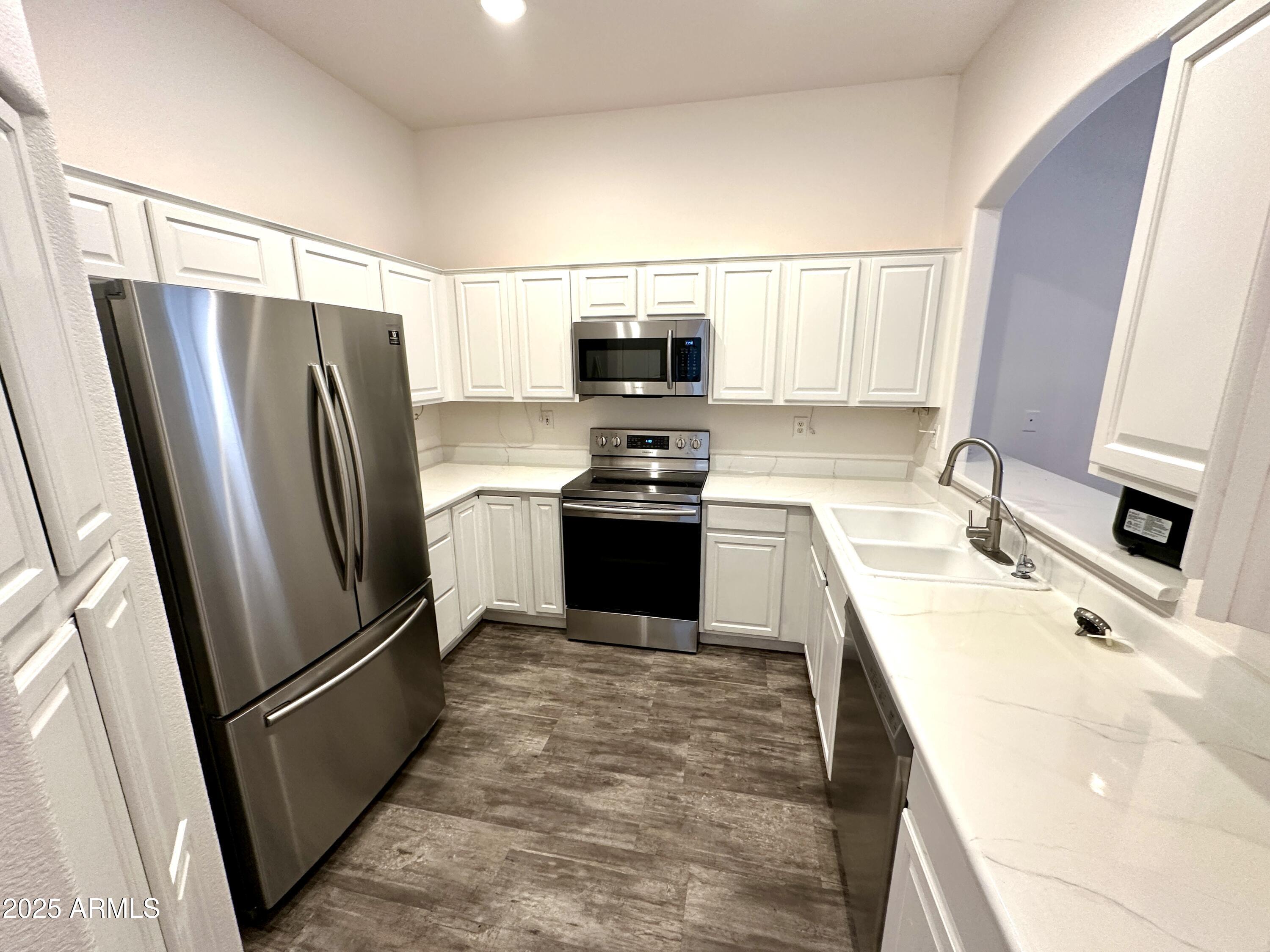 4533 North 22nd Street, Unit 127 Phoenix, AZ 85016 - Photo 7 of 30 a kitchen with a refrigerator sink and wooden floor