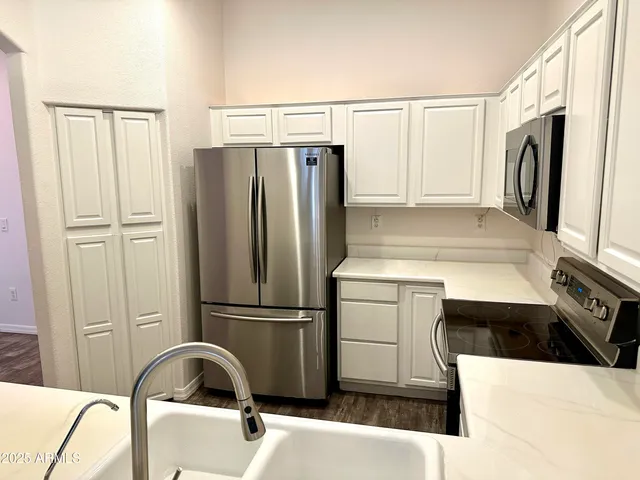 a kitchen with a refrigerator and a sink