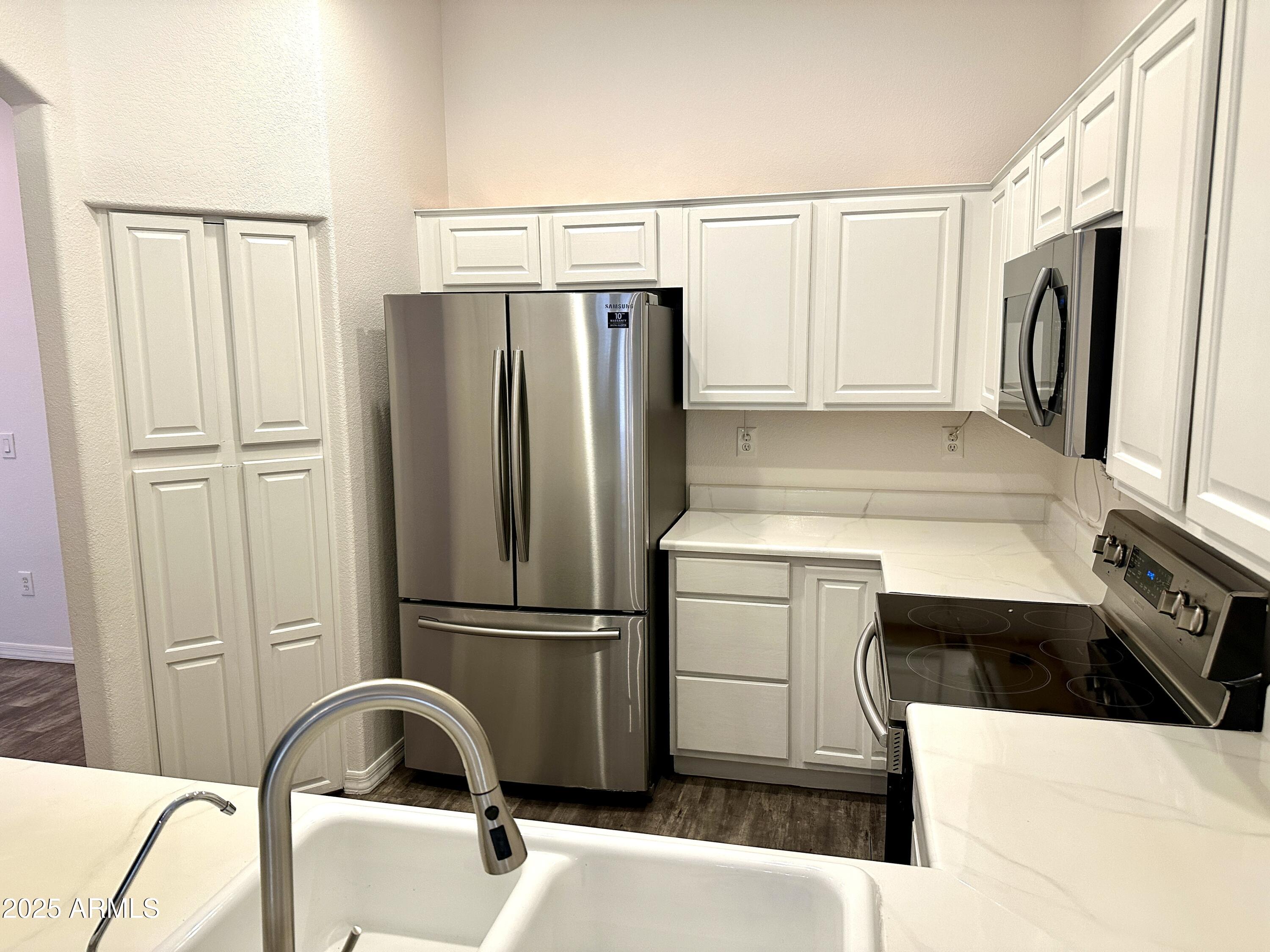 4533 North 22nd Street, Unit 127 Phoenix, AZ 85016 - Photo 9 of 30 a kitchen with a refrigerator and a sink