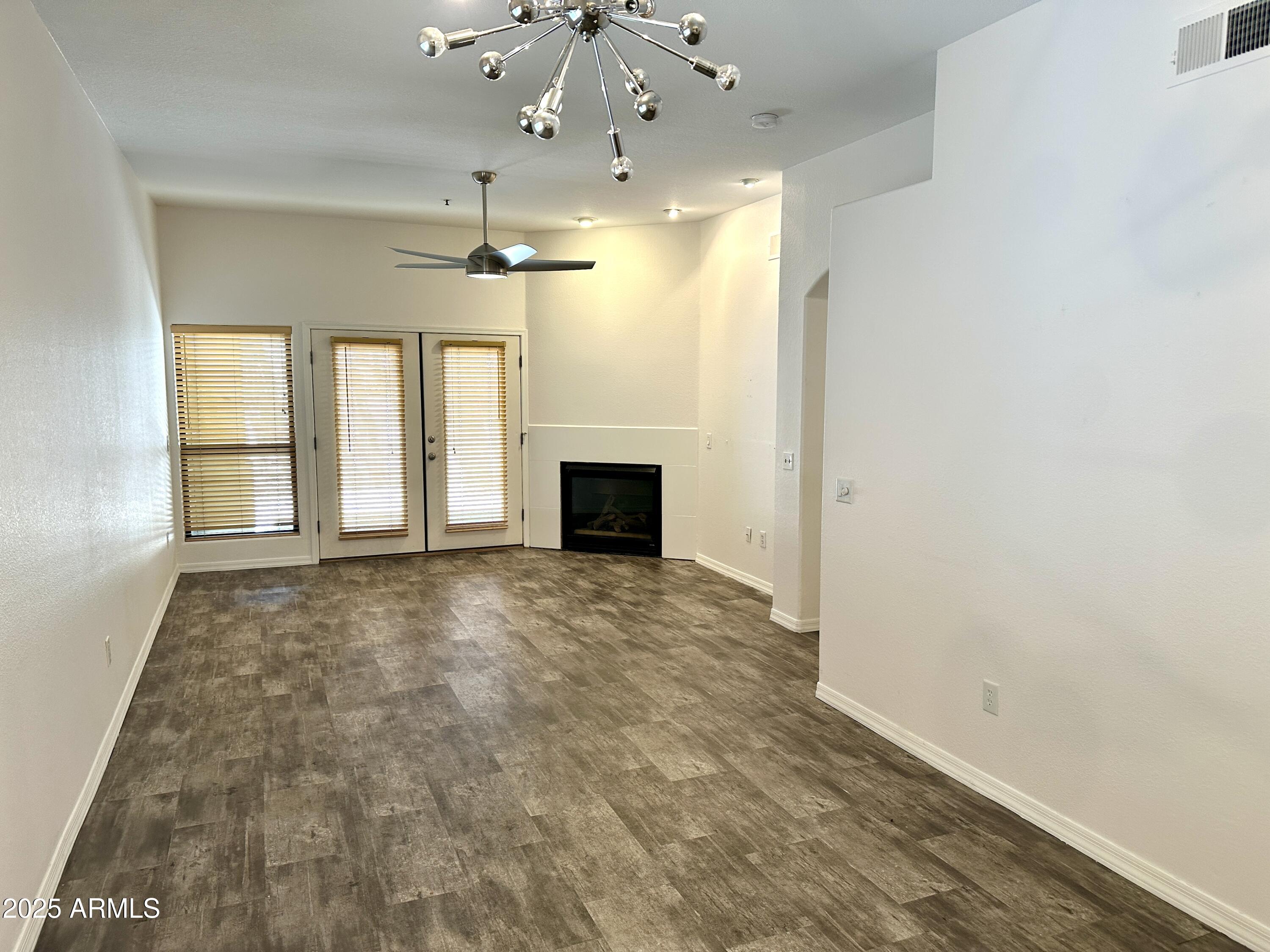 4533 North 22nd Street, Unit 127 Phoenix, AZ 85016 - Photo 10 of 30 an empty room with windows and fireplace
