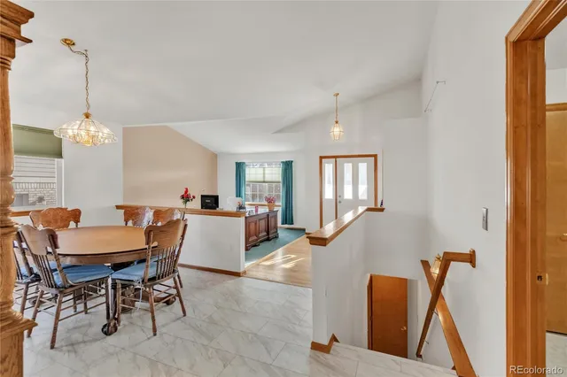 a dining room with furniture and window