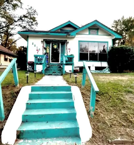 a view of a house with backyard porch and sitting area