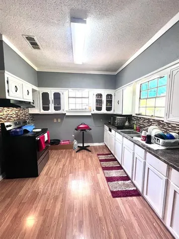 a kitchen with lots of counter top space and a window