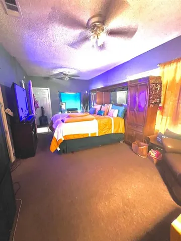 a bedroom with bed and window