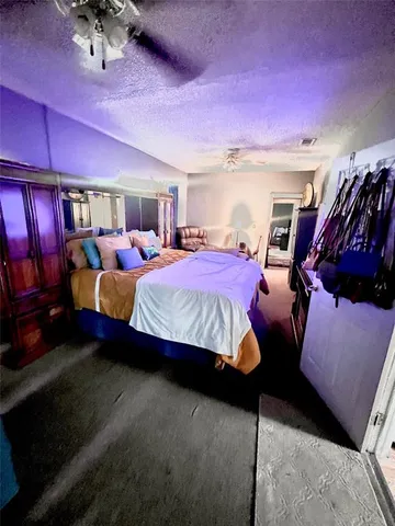 a bedroom with furniture and a chandelier