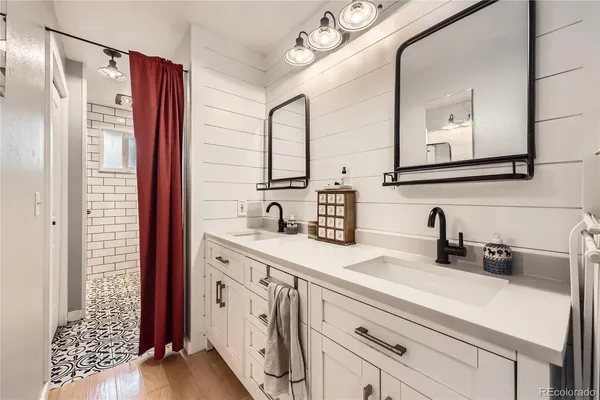 a bathroom with a double vanity sink mirror and