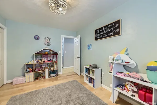 a room with toys and a wooden floor