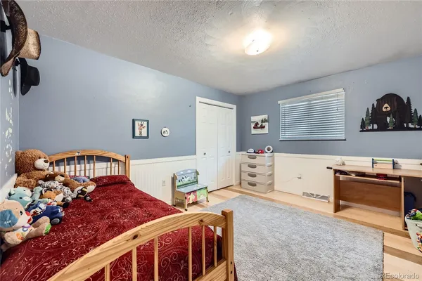 a bedroom with a bed and a tv