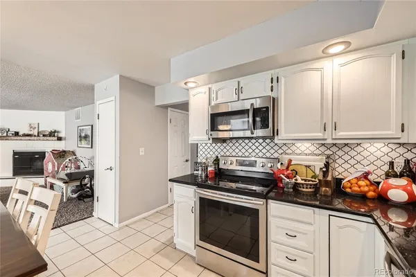 a kitchen with stainless steel appliances a stove a sink cabinets and a counter top space