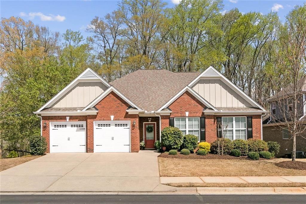 559 Bishopton Street Southeast Grayson, GA 30017 - Photo 1 of 34 a front view of a house with a garden