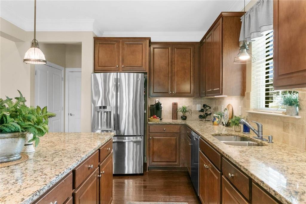559 Bishopton Street Southeast Grayson, GA 30017 - Photo 16 of 34 a kitchen with granite countertop a sink stainless steel appliances and cabinets