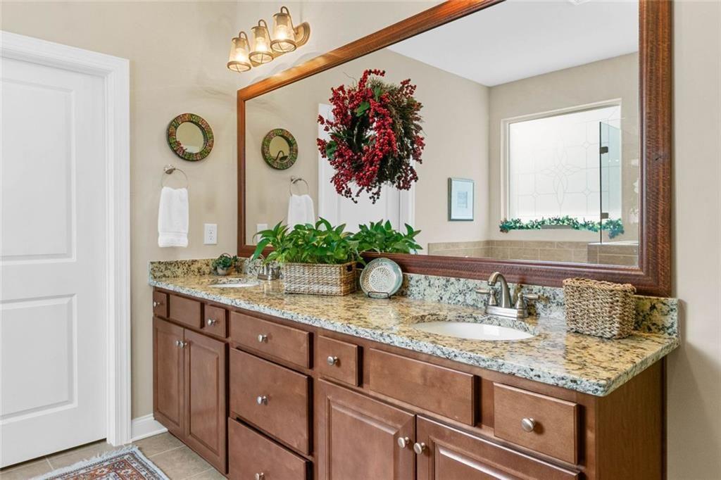 559 Bishopton Street Southeast Grayson, GA 30017 - Photo 26 of 34 a bathroom with a granite countertop sink and a mirror
