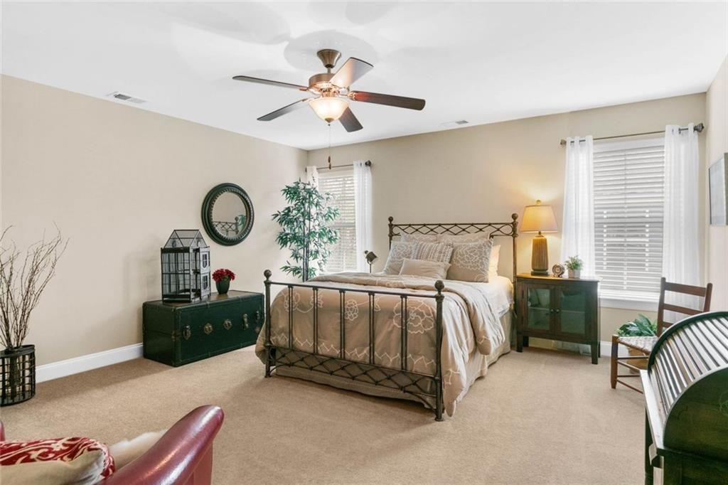 559 Bishopton Street Southeast Grayson, GA 30017 - Photo 28 of 34 a bedroom with a bed and a chandelier