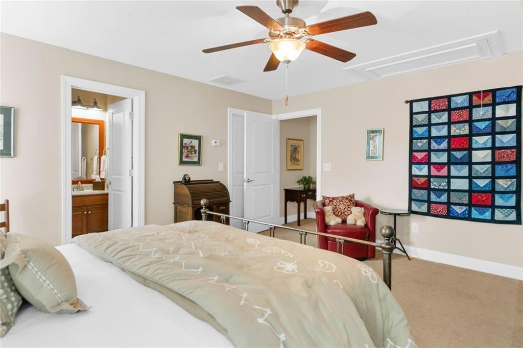 559 Bishopton Street Southeast Grayson, GA 30017 - Photo 29 of 34 a bedroom with a bed and a chandelier
