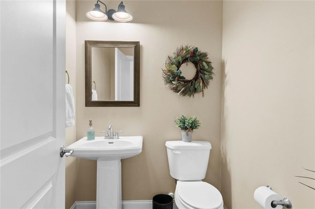 559 Bishopton Street Southeast Grayson, GA 30017 - Photo 5 of 34 a bathroom with a toilet sink and mirror