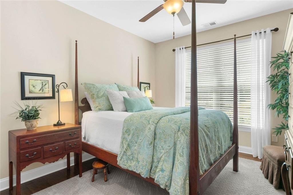 559 Bishopton Street Southeast Grayson, GA 30017 - Photo 6 of 34 a bedroom with a large bed and a chandelier