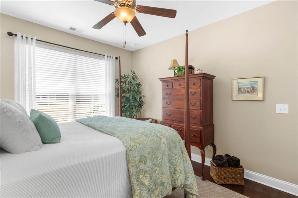 559 Bishopton Street Southeast Grayson, GA 30017 - Photo 7 of 34 a bedroom with a bed and a chandelier