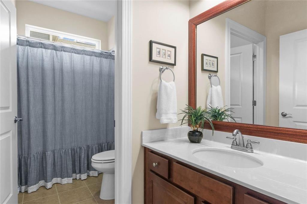 559 Bishopton Street Southeast Grayson, GA 30017 - Photo 8 of 34 a bathroom with a granite countertop sink toilet and mirror