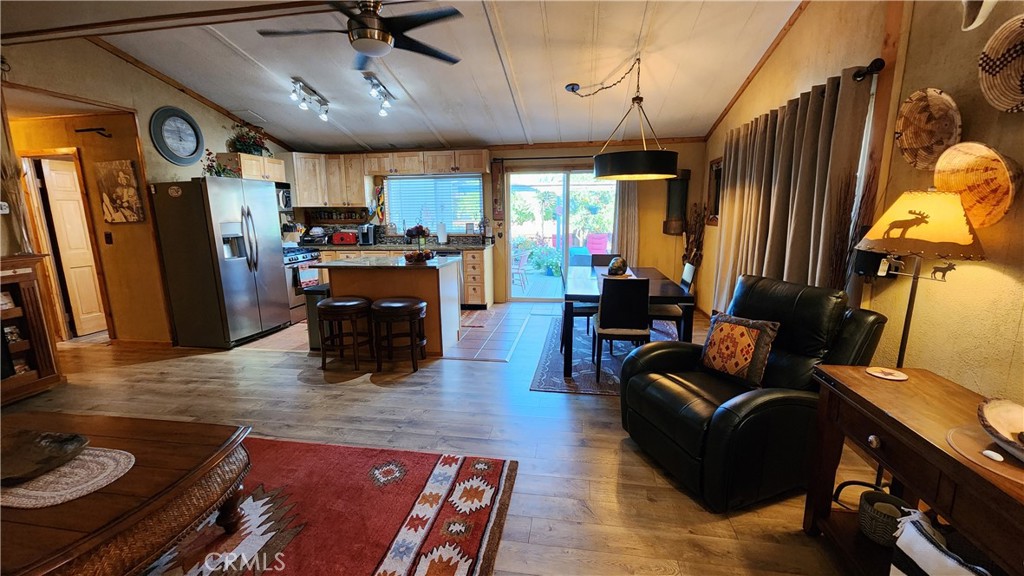 81641 Ave 48, Unit SPC 104 Indio, CA 92201 - Photo 16 of 50 a living room with furniture and a flat screen tv