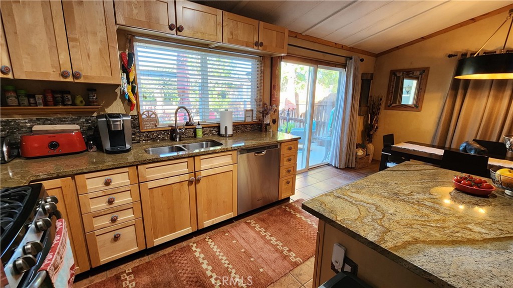 81641 Ave 48, Unit SPC 104 Indio, CA 92201 - Photo 25 of 50 a kitchen with stainless steel appliances granite countertop sink stove and refrigerator
