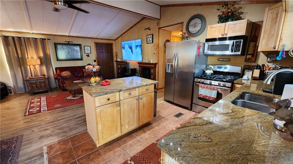 81641 Ave 48, Unit SPC 104 Indio, CA 92201 - Photo 26 of 50 a kitchen with stainless steel appliances granite countertop a refrigerator a stove top oven a sink and dishwasher