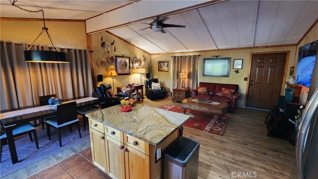 81641 Ave 48, Unit SPC 104 Indio, CA 92201 - Photo 28 of 50 a living room with a table chairs and a refrigerator