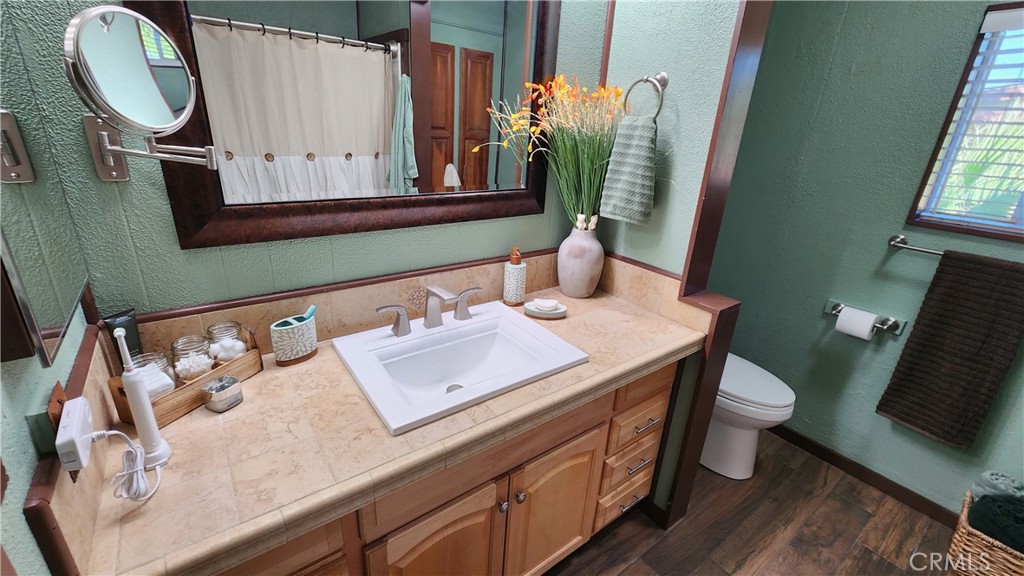 81641 Ave 48, Unit SPC 104 Indio, CA 92201 - Photo 32 of 50 a bathroom with a toilet sink and mirror
