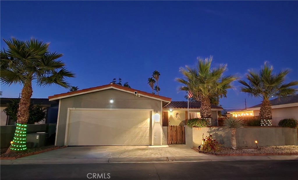 81641 Ave 48, Unit SPC 104 Indio, CA 92201 - Photo 4 of 50 a front view of a house with a yard