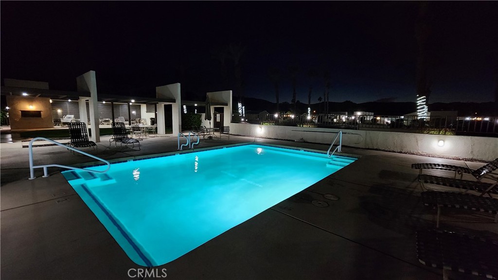 81641 Ave 48, Unit SPC 104 Indio, CA 92201 - Photo 42 of 50 a view of a swimming pool with an outdoor seating