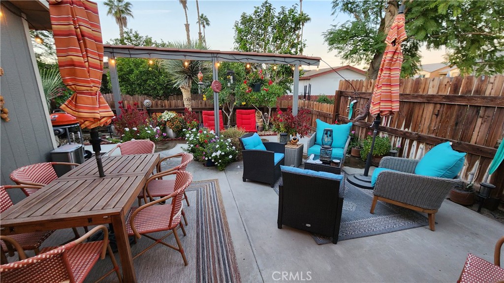 81641 Ave 48, Unit SPC 104 Indio, CA 92201 - Photo 5 of 50 a view of a chairs and tables in the back yard of the house