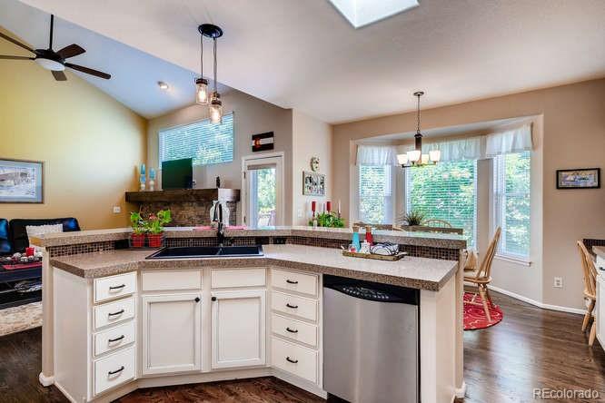 809 Huntington Place Highlands Ranch, CO 80126 - Photo 8 of 28 a kitchen with a sink stove and cabinets