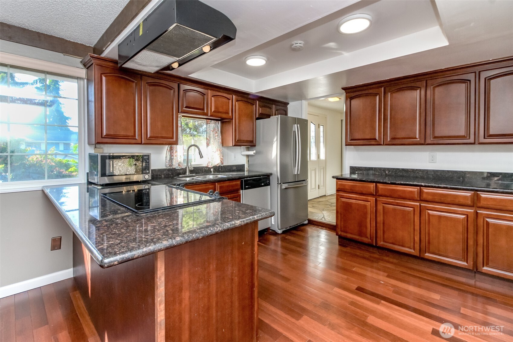 32622 39th Avenue Southwest Federal Way, WA 98023 - Photo 15 of 40 a kitchen with stainless steel appliances granite countertop a refrigerator a sink dishwasher a stove and white countertops with wooden floor