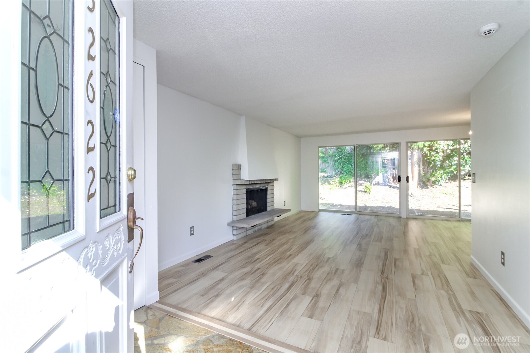 32622 39th Avenue Southwest Federal Way, WA 98023 - Photo 4 of 40 wooden floor in an empty room with a fireplace