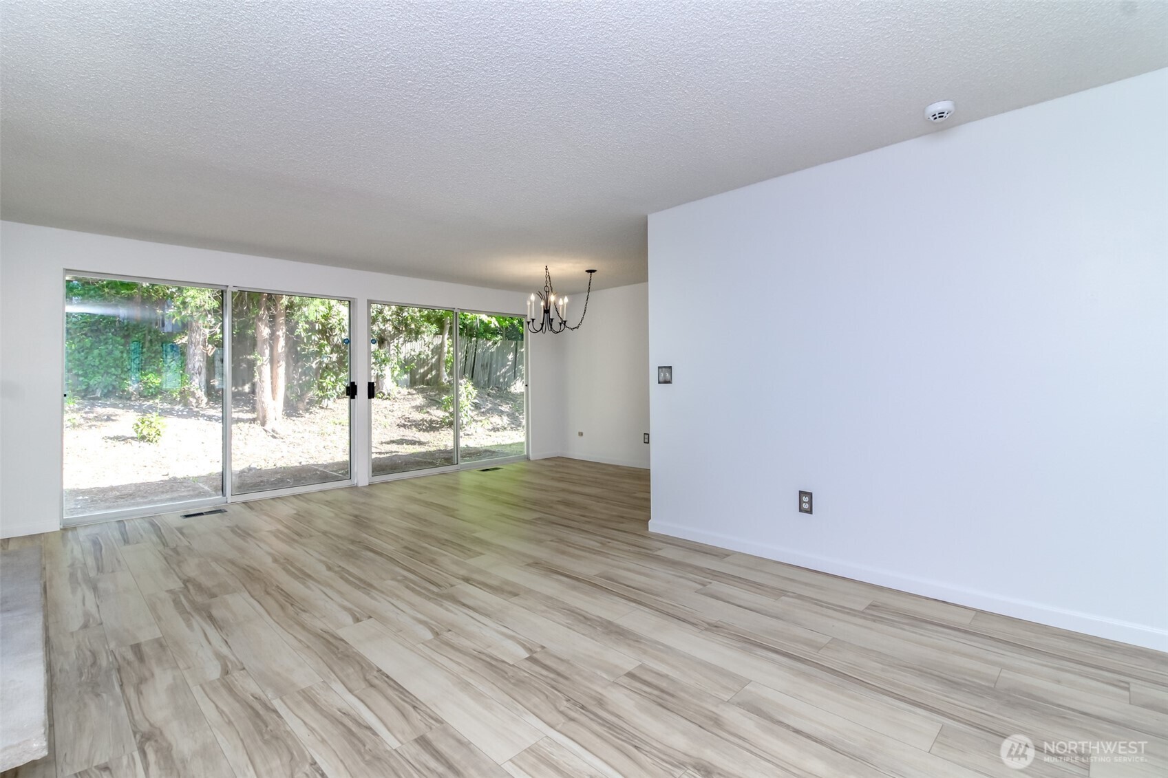 32622 39th Avenue Southwest Federal Way, WA 98023 - Photo 6 of 40 an empty room with wooden floor and windows