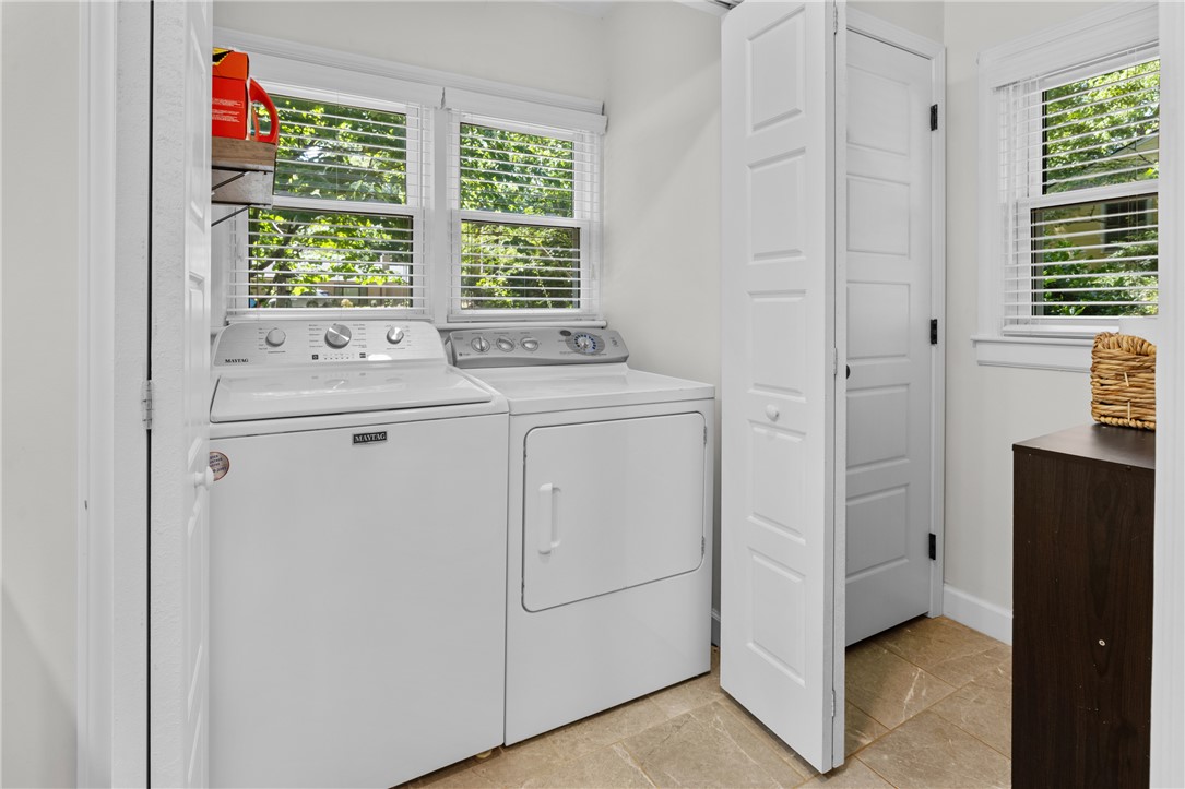 203 Augusta Road Clemson, SC 29631 - Photo 24 of 31 Functional laundry space featuring a window-lined wall, tile flooring, and essential washer and dryer units located in the primary bath.