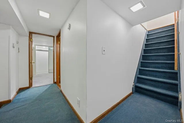 a view of a hallway with entryway and stairs