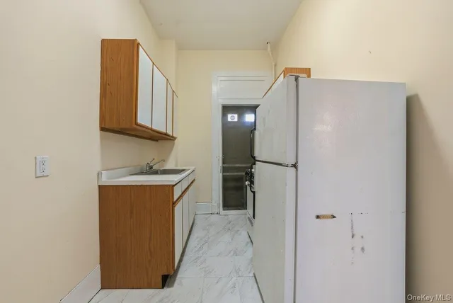 a kitchen with stainless steel appliances granite countertop a refrigerator and a sink