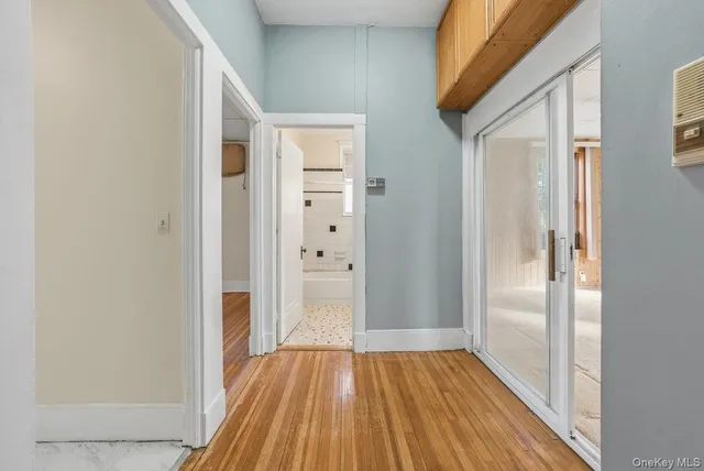 a view of a hallway with wooden floor