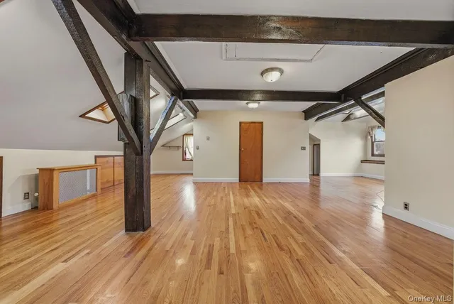 a view of a room with wooden floor